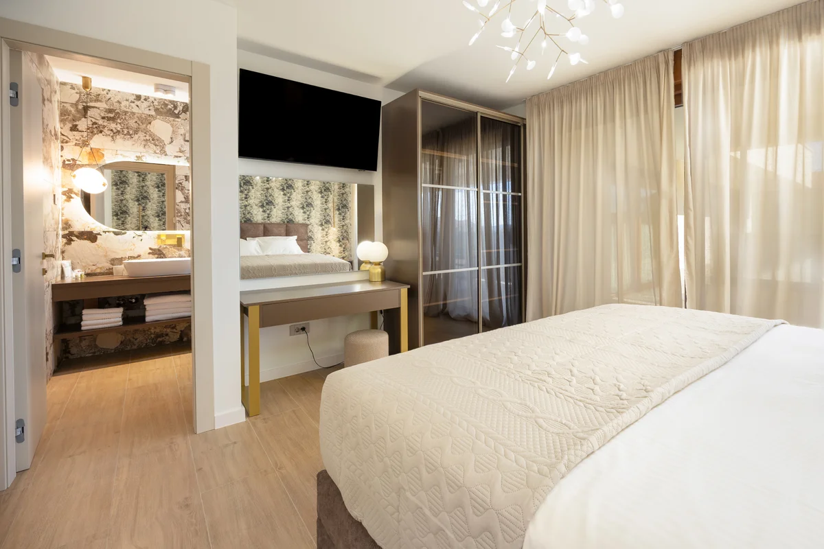 a room with a bed and a mirror