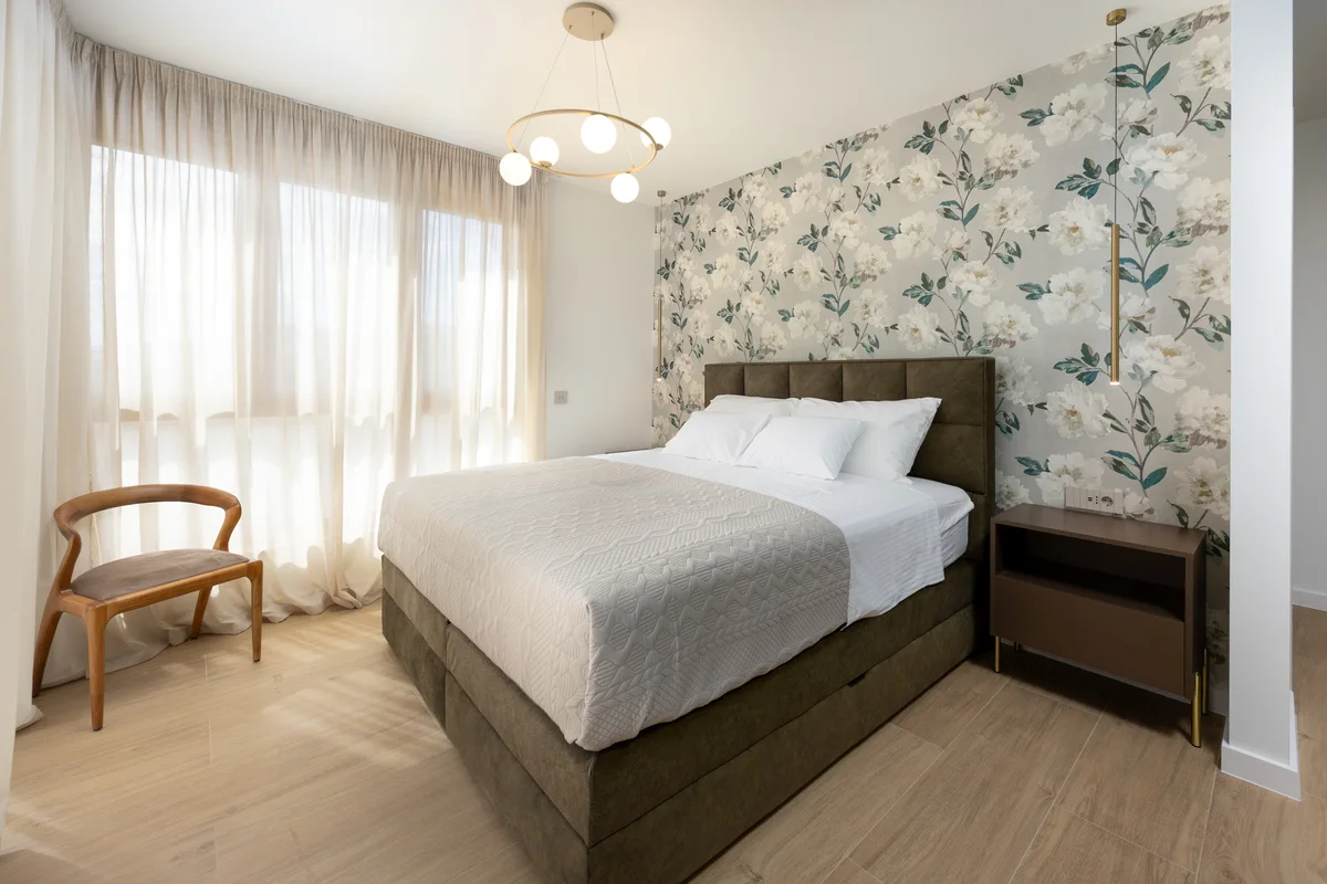 a bedroom with a bed and a chair