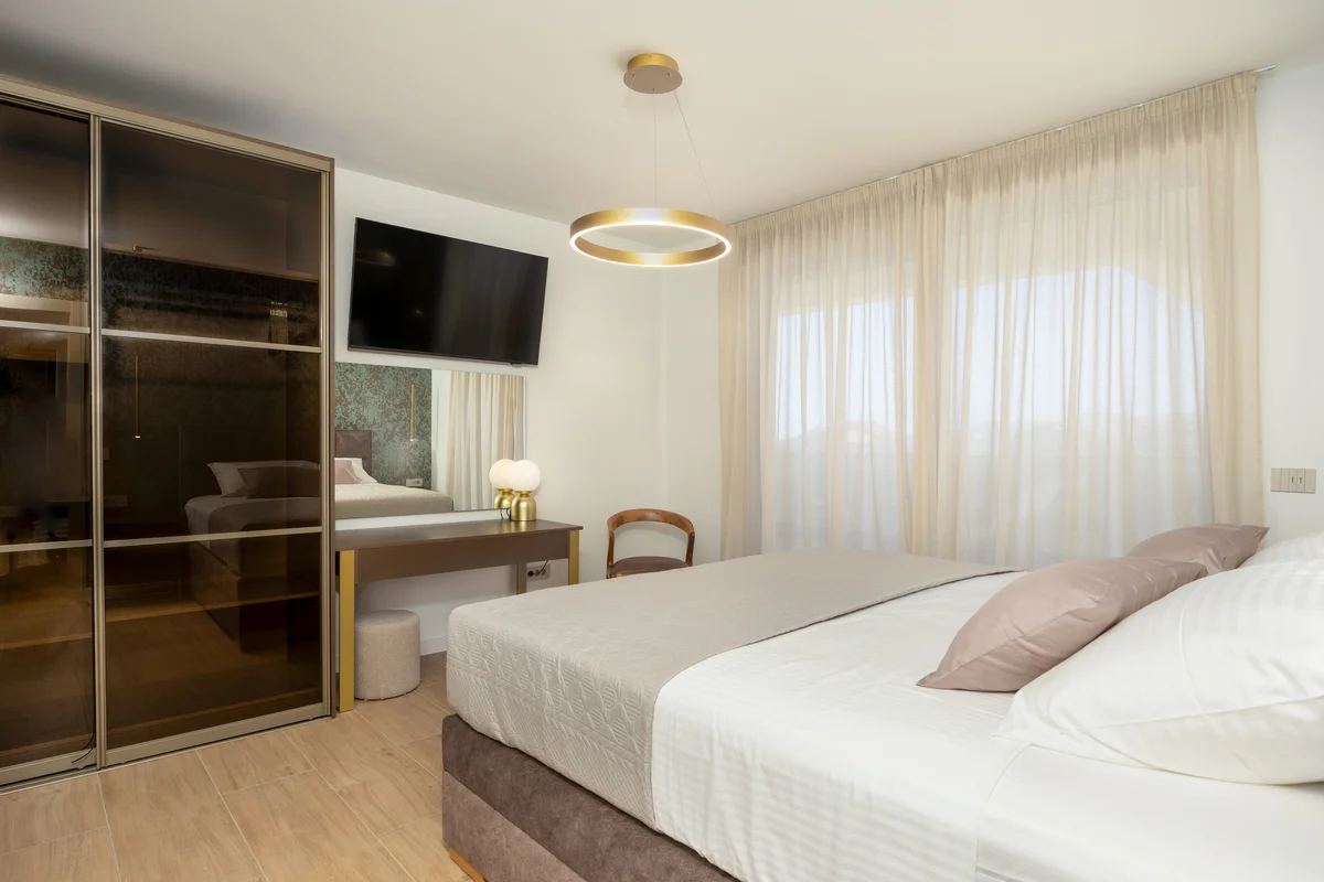 a bedroom with a bed and a tv