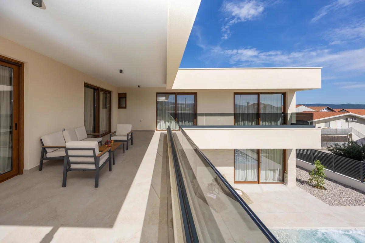 a balcony with a table and chairs
